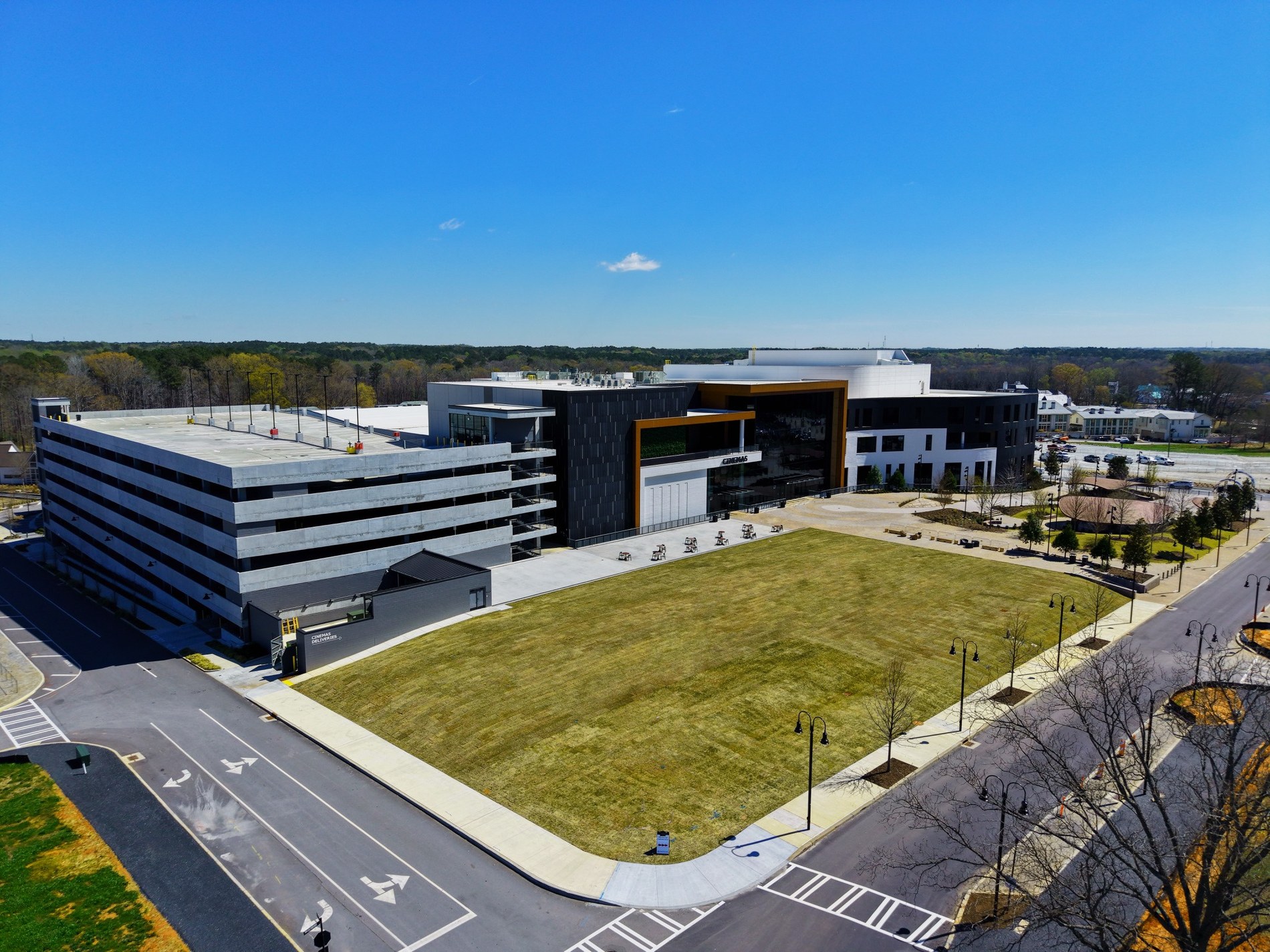 Wide aerial image of large modern building and surrounding grounds